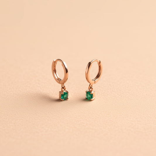 [variant:Vouves Earrings] Gold hoop earrings with green chalcedony gemstone drops displayed on a soft beige background